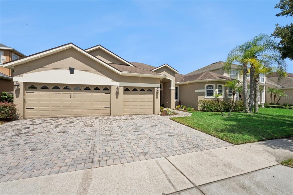 A living room with purple armchairs, a glass coffee table, and a fireplace — 3149 CURVING OAKS WAY, ORLANDO, FL