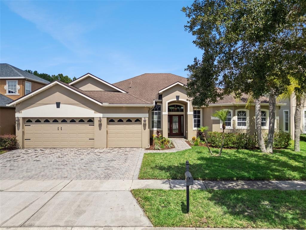 A living room features a fireplace, tile flooring, a ceiling fan, and sliding glass doors — 3149 CURVING OAKS WAY, ORLANDO, FL