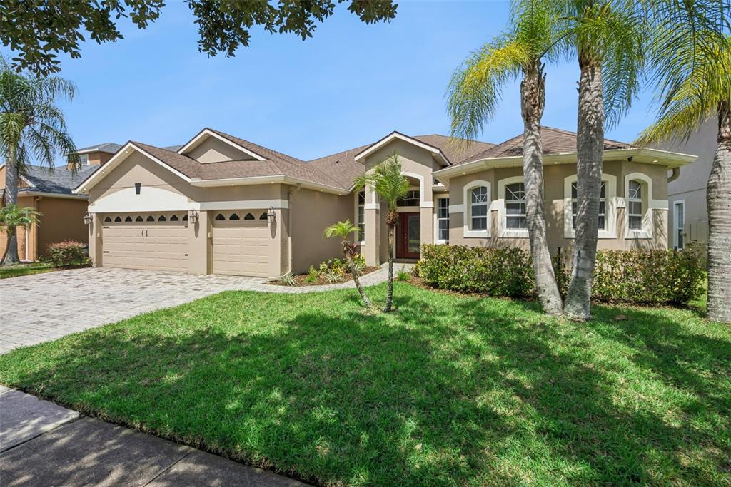 A living room features a fireplace, two purple armchairs, a ceiling fan, and sliding glass doors — 3149 CURVING OAKS WAY, ORLANDO, FL