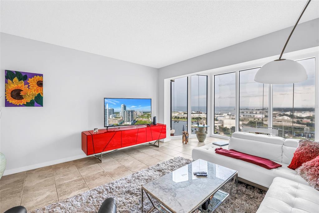 A bathroom features a glass-enclosed shower, a vessel sink on a vanity, and tile flooring — 1 BEACH DRIVE SE UNIT 1907, ST PETERSBURG, FL