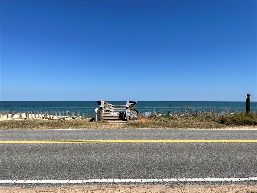 A wooden beach access staircase sits between a coastal road and the ocean — 3651 S CENTRAL AVE UNIT 312, FLAGLER BEACH, FL