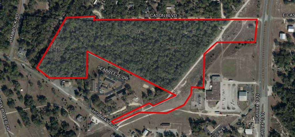 An aerial map shows a large, irregularly shaped plot of land outlined in red — 0 S SUNCOAST BOULEVARD, INGLIS, FL