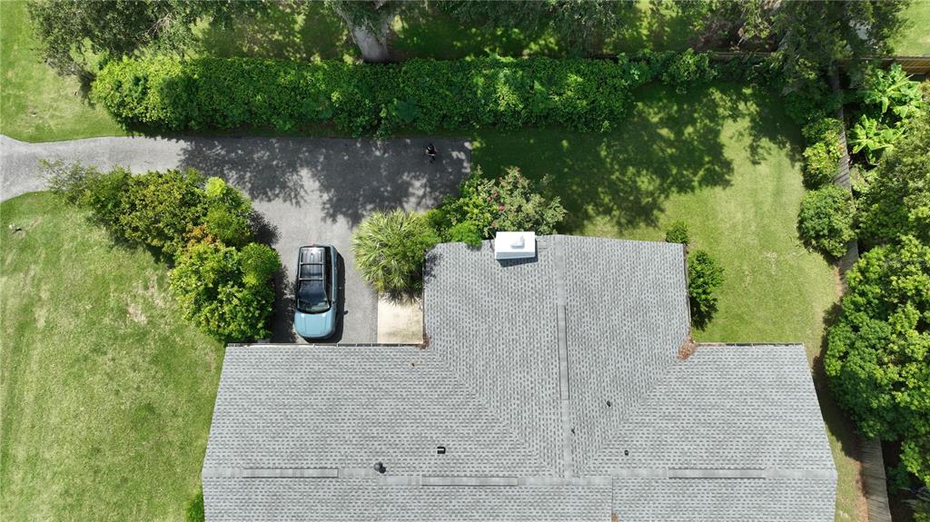 A single-story house with a gray exterior, a white garage door, and a paved driveway — 2190 SE 39TH STREET, OCALA, FL
