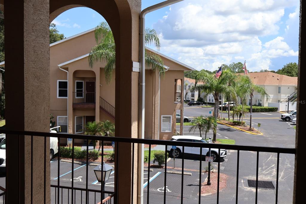 A brown front door with a keypad lock is situated next to a window with blinds — 8842 CORAL PALMS COURT UNIT B, KISSIMMEE, FL