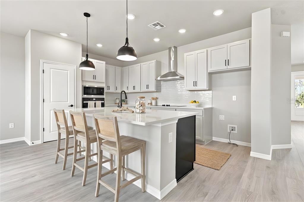 This is a floor plan of a home's main level with a two-car garage — 3395 YELLOW CASSIA DRIVE, WESLEY CHAPEL, FL
