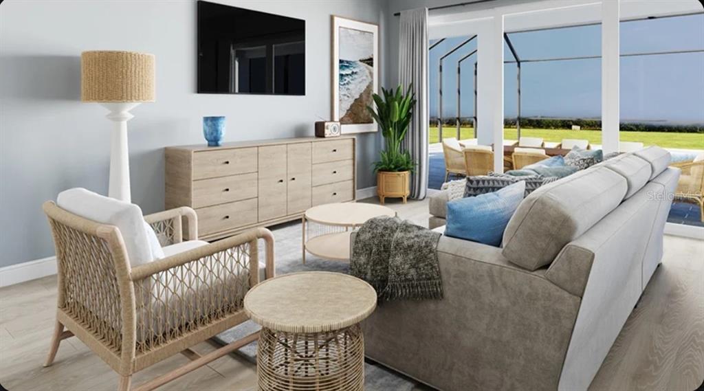 This rendering shows a living room with a sofa, armchair, media console, and patio view — 10585 ECLIPSE STREET, SARASOTA, FL