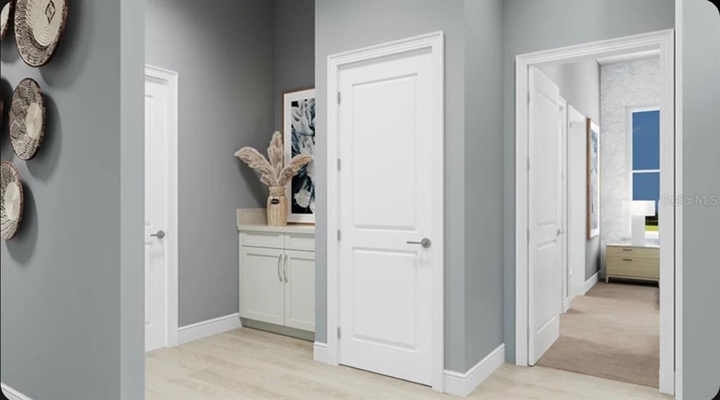 This rendering shows a gray hallway with white doors, a small cabinet, and wall decor — 10585 ECLIPSE STREET, SARASOTA, FL
