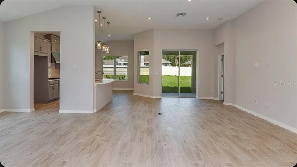 A kitchen with gray cabinets, white countertops, a center island, and stainless steel appliances — 5769 BINNACLE LANE, COCOA, FL