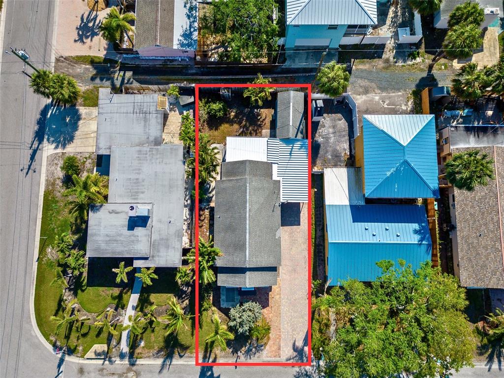 An aerial view shows a residential property with a house, driveway, and backyard — 3108 DUPONT STREET S, GULFPORT, FL