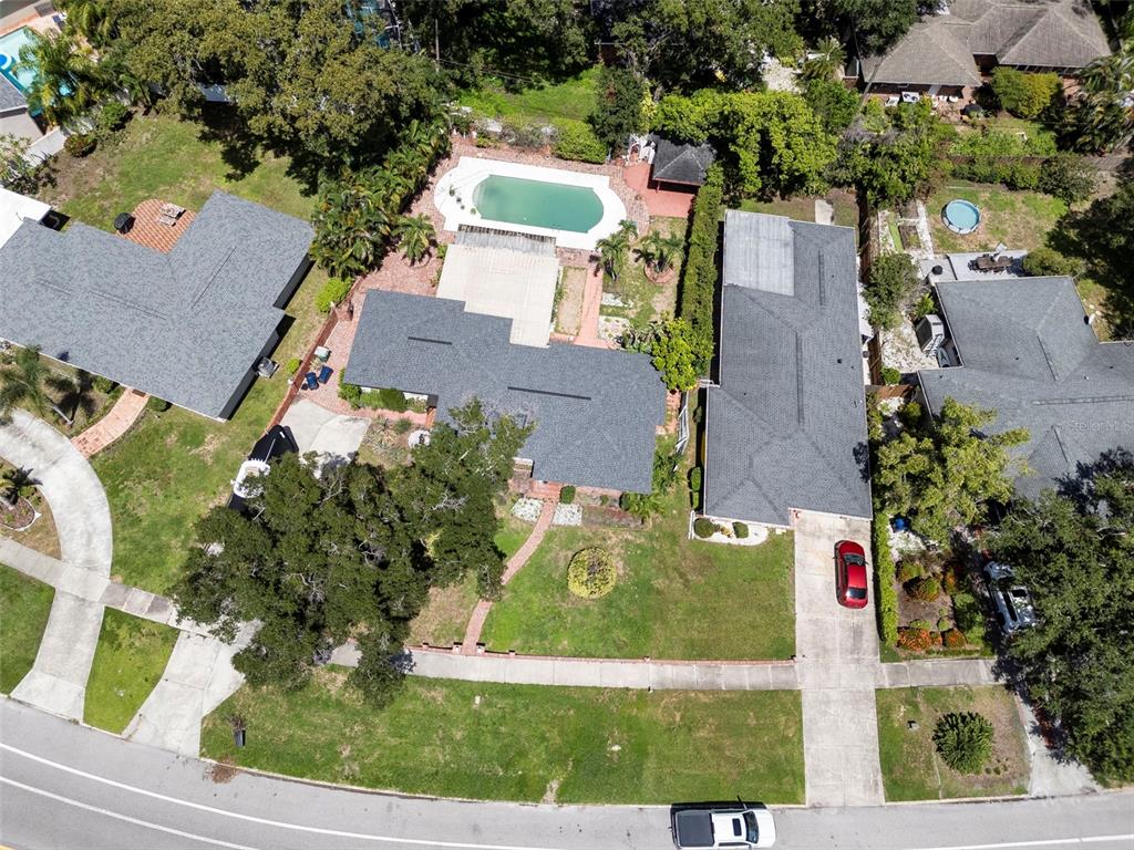 An aerial view shows two adjacent houses with swimming pools and driveways in a residential neighborhood — 451 W DAVIS BOULEVARD, TAMPA, FL
