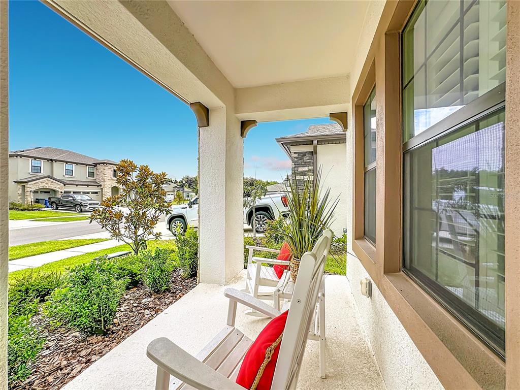 A foyer features double glass-paneled doors, a light wood console table, and dark wood flooring — 13150 WELLSPRING DRIVE, LITHIA, FL