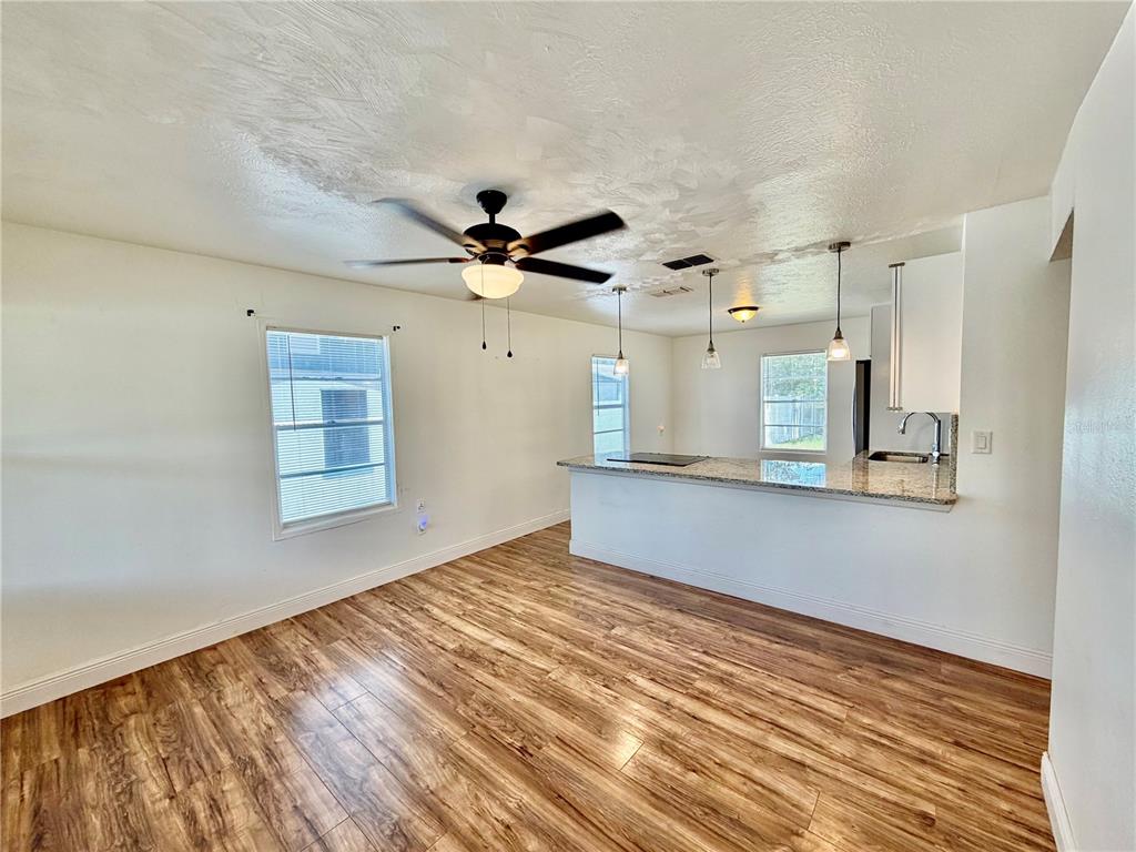 A single-story house with light gray siding and a front porch sits on a grassy lot — 311 W BELLA VISTA STREET, LAKELAND, FL