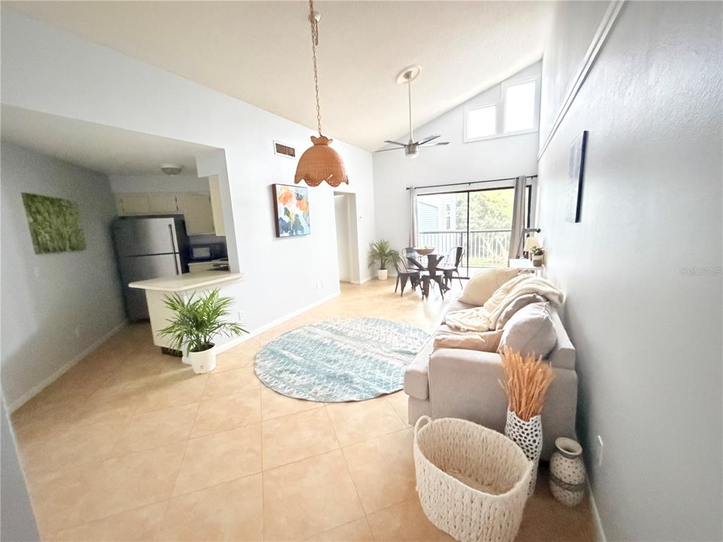 A bedroom features beige carpeting, light blue walls, a ceiling fan, and a window with curtains — 3914 ATRIUM DRIVE bldg36, ORLANDO, FL