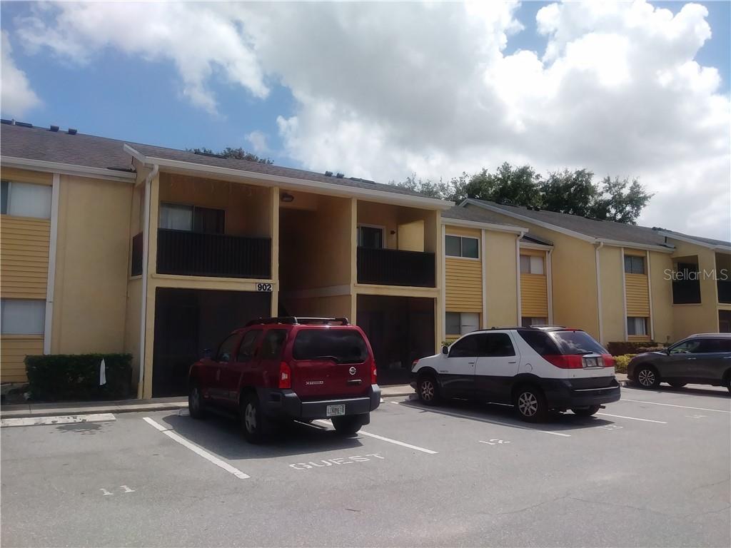 A two-story apartment building with yellow siding and a parking lot in front — 902 LAKE DESTINY ROAD UNIT B, ALTAMONTE SPRINGS, FL