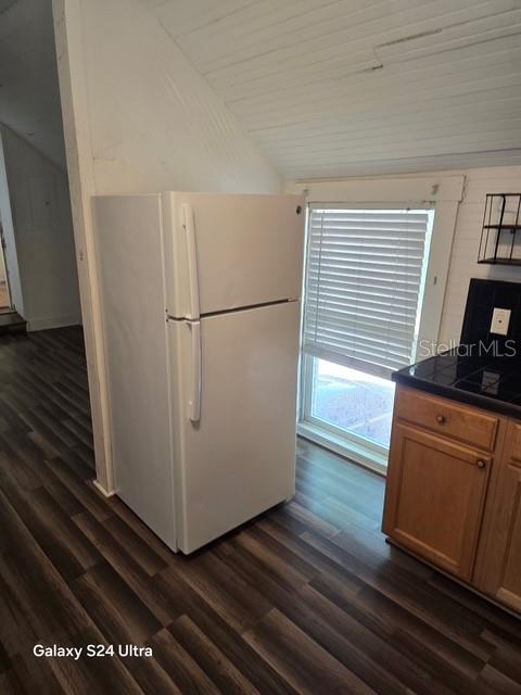 A white refrigerator stands in a kitchen with wood-look flooring and a window with blinds — 7306 EARLWOOD AVENUE UNIT 5, MOUNT DORA, FL