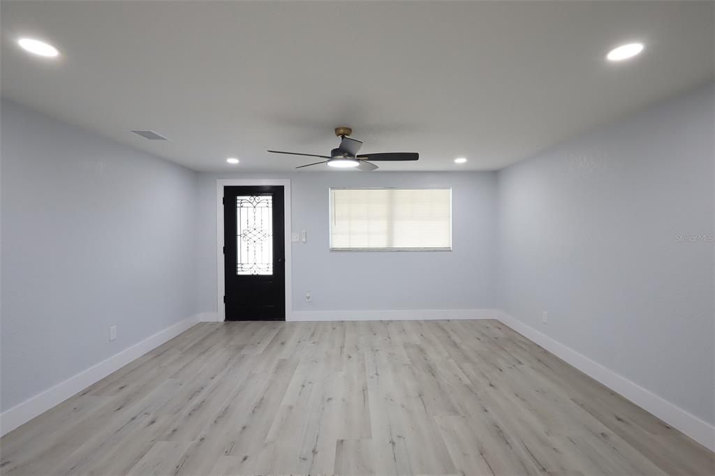 A single-story house with a large tree in the front yard and a chain-link fence — 505 CLEARFIELD ROAD, BRANDON, FL