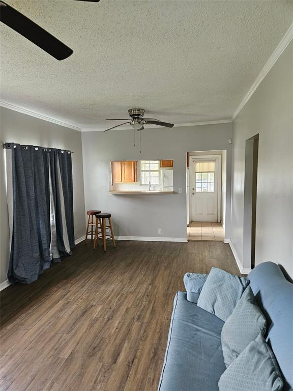 A single-story house with light siding, a metal roof, and a blue front door — 220 DIXIE HIGHWAY, AUBURNDALE, FL