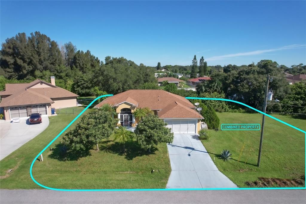 An aerial view shows a single-story house with a brown roof and a large yard — 12004 SARTO LANE, NORTH PORT, FL