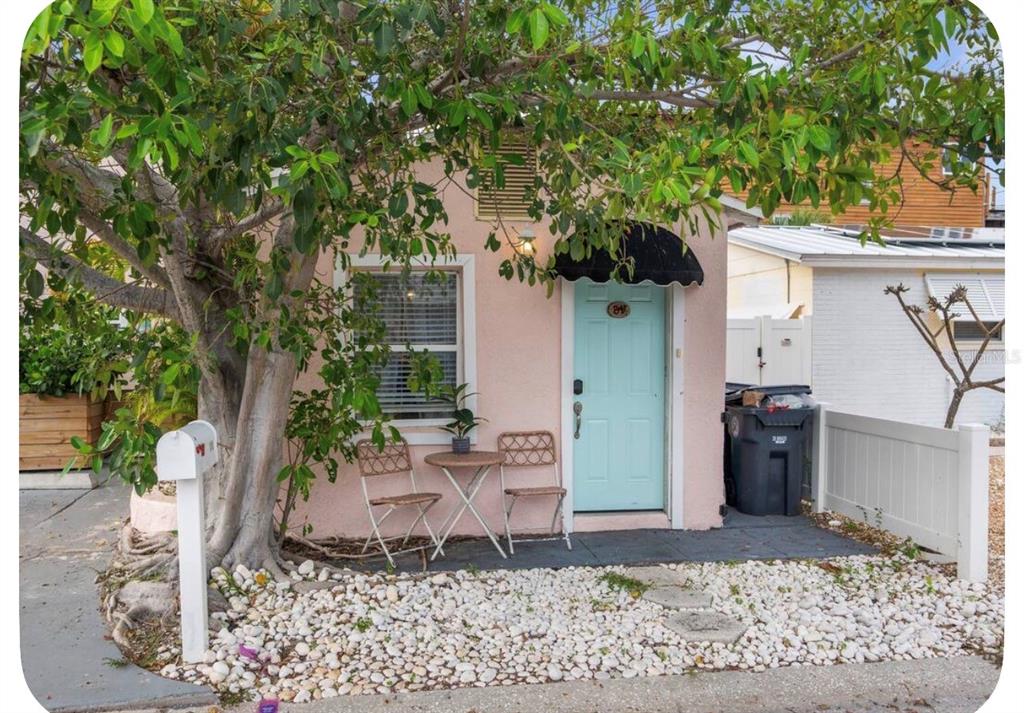 A before and after comparison shows a small house elevated on stilts to create space — 106 E BAY DRIVE, TREASURE ISLAND, FL