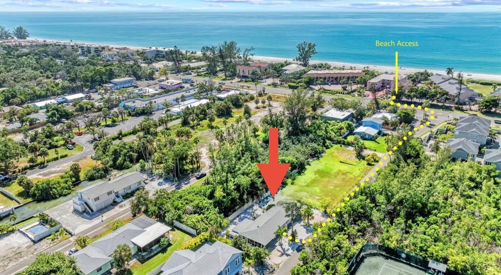 An aerial view shows a house with a red arrow pointing toward it near a beach — 578 - 580 COMPANION WAY, LONGBOAT KEY, FL