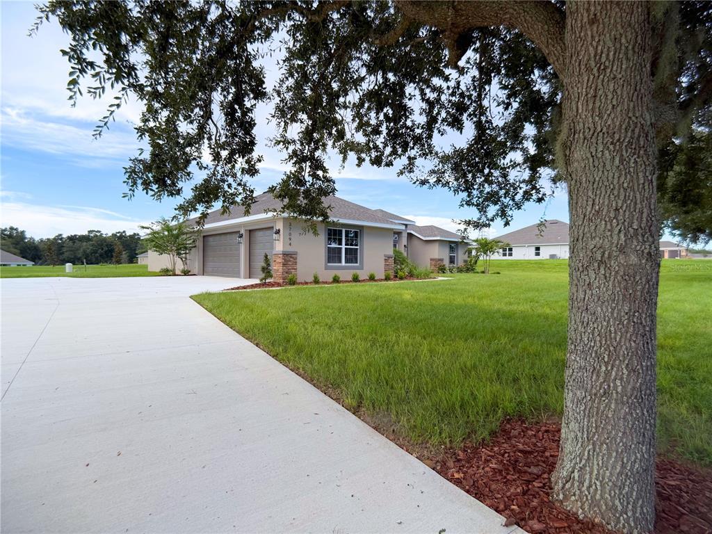 This is a digital rendering of a single-story suburban house with a two-car garage — 37094 HIDDEN VIEW CIRCLE, DADE CITY, FL