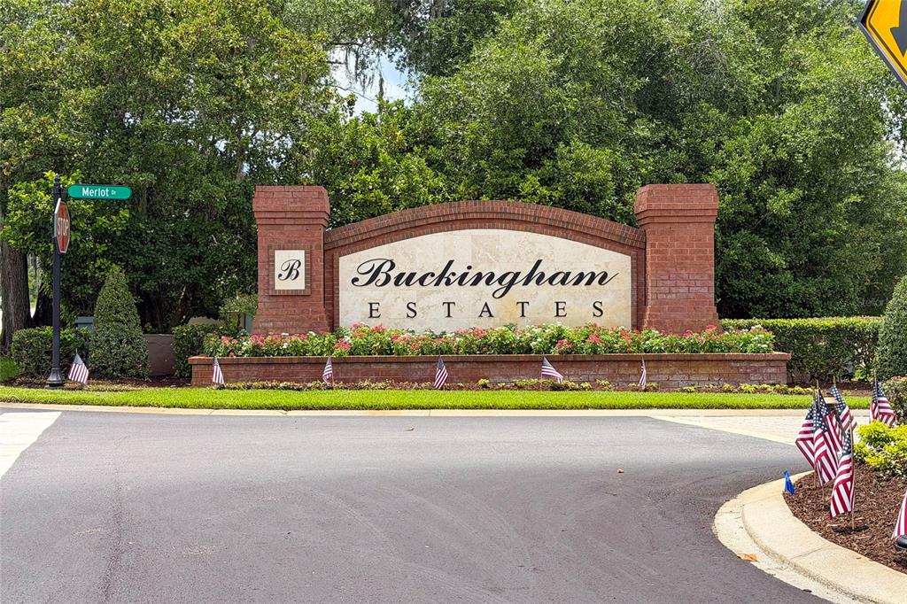 A brick entrance sign for Bentley at Buckingham Estates sits behind a landscaped flower bed — 6230 BORDEAUX CIRCLE, SANFORD, FL