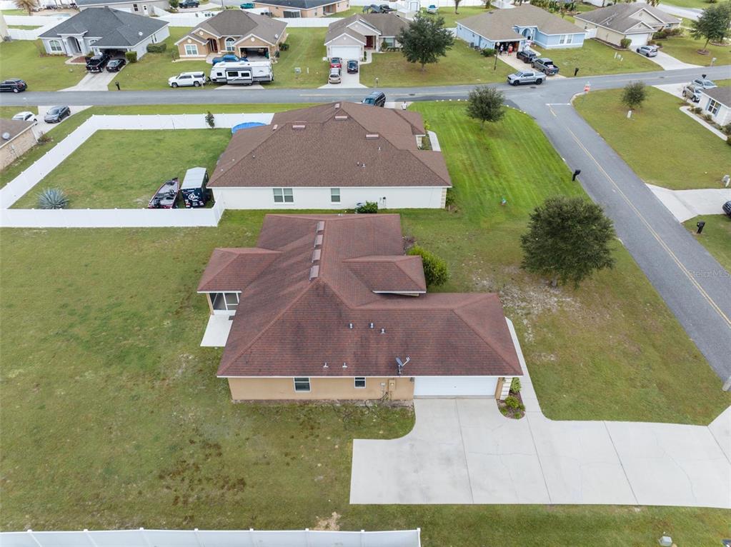 An aerial view shows a single-story house with a brown roof and a concrete driveway — 5749 SW 98TH PLACE, OCALA, FL