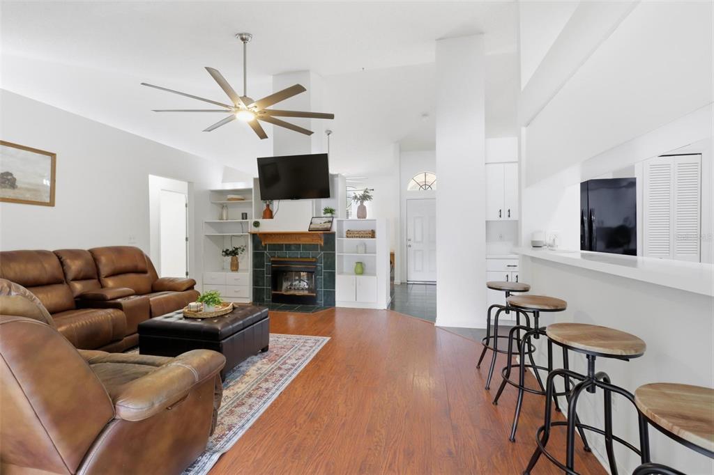A single-story house with a beige stucco exterior, brown roof, and a large front lawn — 731 EDGEWILD COURT, ORANGE CITY, FL