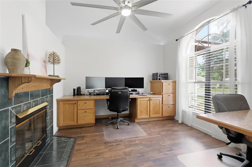 A tan house with a brown roof and a two-car garage sits on a lot — 731 EDGEWILD COURT, ORANGE CITY, FL