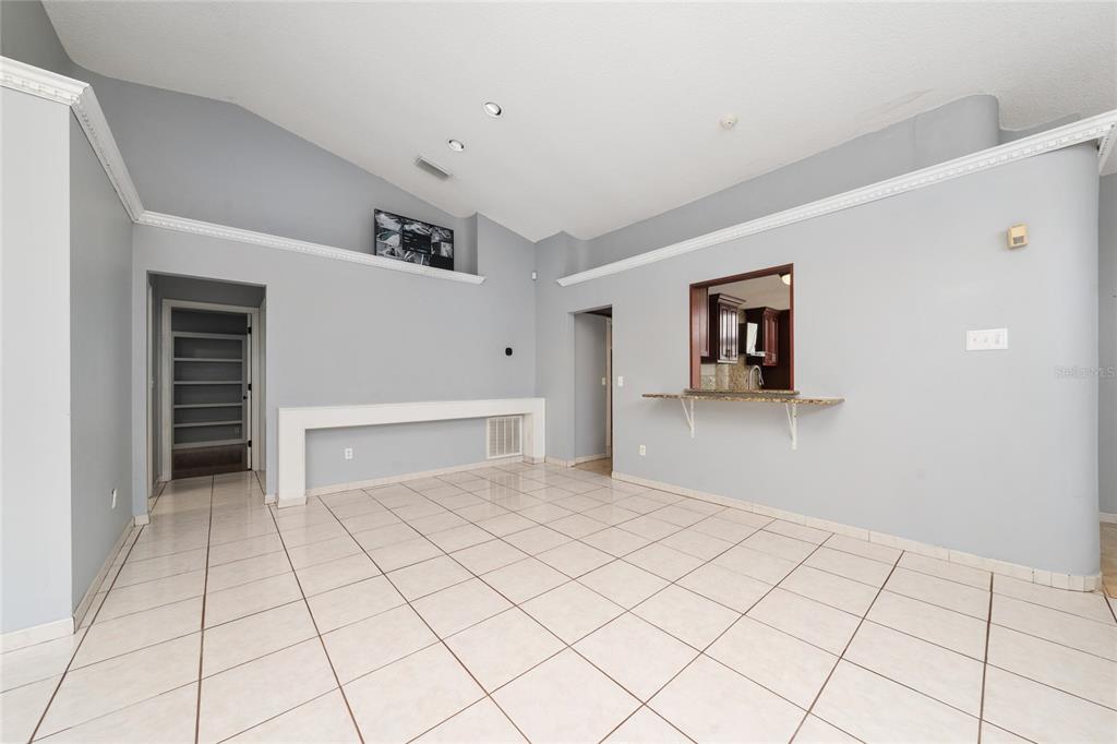 A kitchen breakfast nook features tile flooring, a bay window, and a built-in double oven — 8810 KENSINGTON COURT, KISSIMMEE, FL