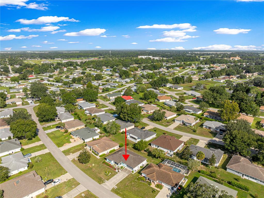 An aerial view shows a residential neighborhood with a single-story house highlighted by a red arrow — 6201 SW 84TH PLACE, OCALA, FL