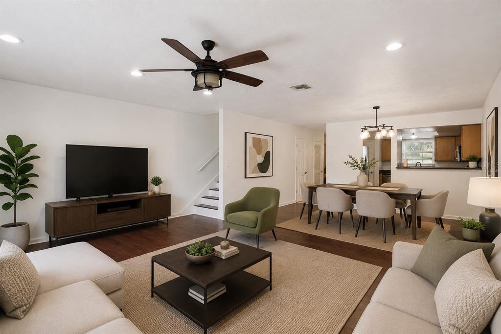 A spacious room features dark wood-look flooring, white walls, a ceiling fan, and sliding glass doors — 193 LEWFIELD CIRCLE, WINTER PARK, FL