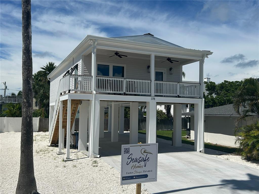 An aerial view shows a house with a red location pin near a coastal waterway — 108 125TH AVENUE, TREASURE ISLAND, FL