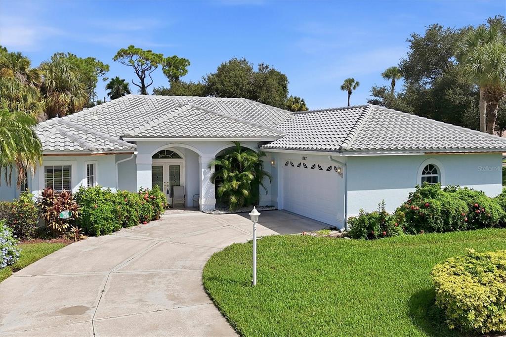 A covered patio features a swimming pool, outdoor furniture, and a screened-in enclosure — 1787 KILRUSS DRIVE, VENICE, FL