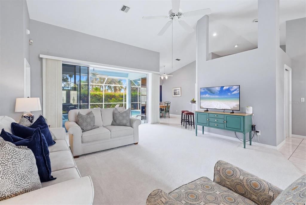 A light blue house exterior features a covered entryway, double front doors, and a garage — 1787 KILRUSS DRIVE, VENICE, FL