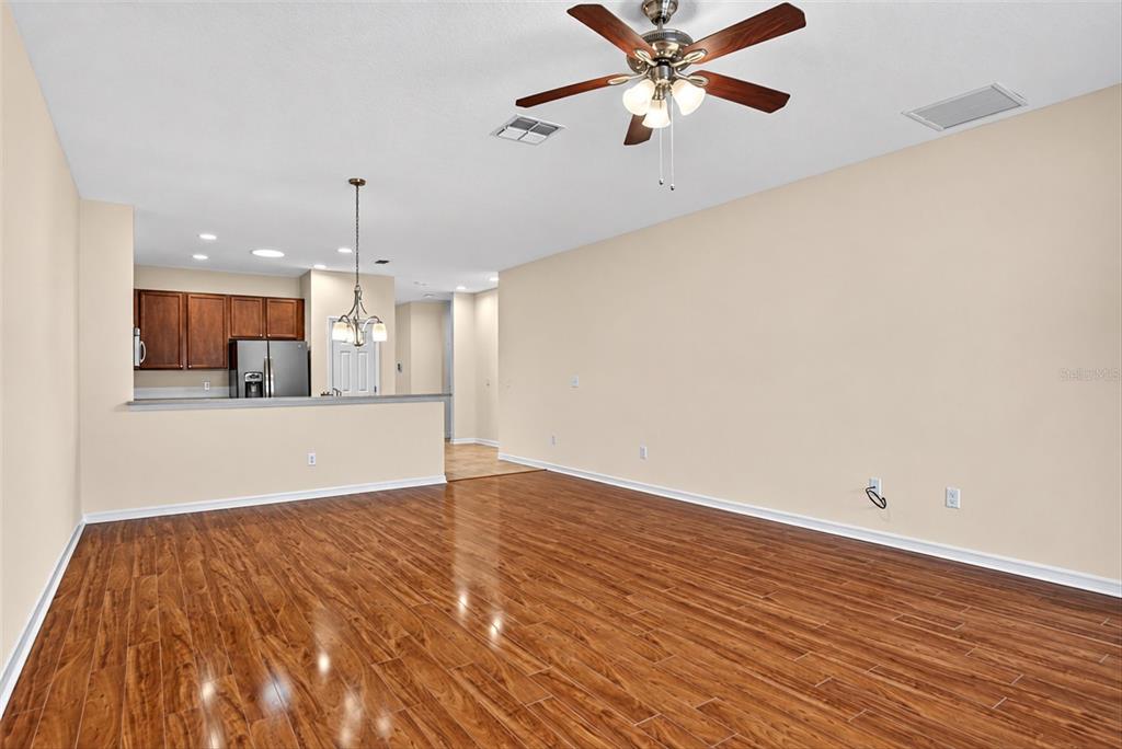 A gray single-story house with a two-car garage, palm trees, and a landscaped front yard — 2153 BARRACUDA COURT, HOLIDAY, FL
