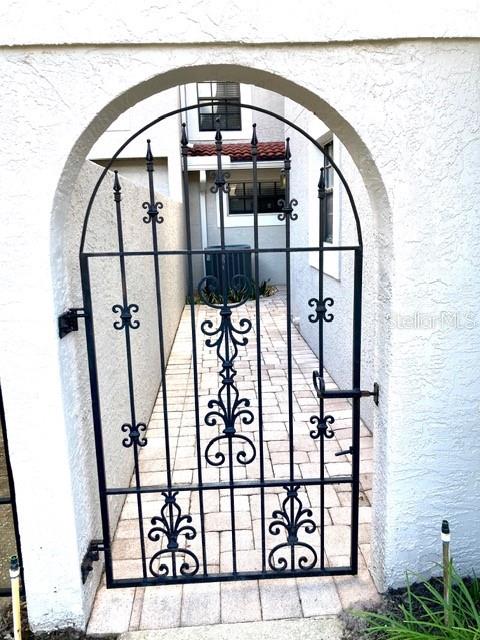 A white front door with a decorative rug sits on a paved entryway — 8214 AMBROSE COVE WAY, ORLANDO, FL