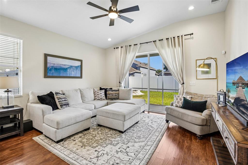 An exterior view of a single-story house with a two-car garage and a palm tree — 4907 58TH TERRACE E, BRADENTON, FL