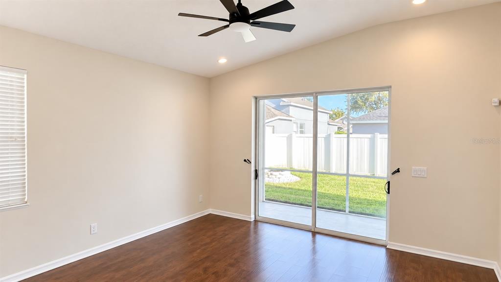 A single-story house with a two-car garage, light-colored stucco siding, and a manicured lawn — 4907 58TH TERRACE E, BRADENTON, FL