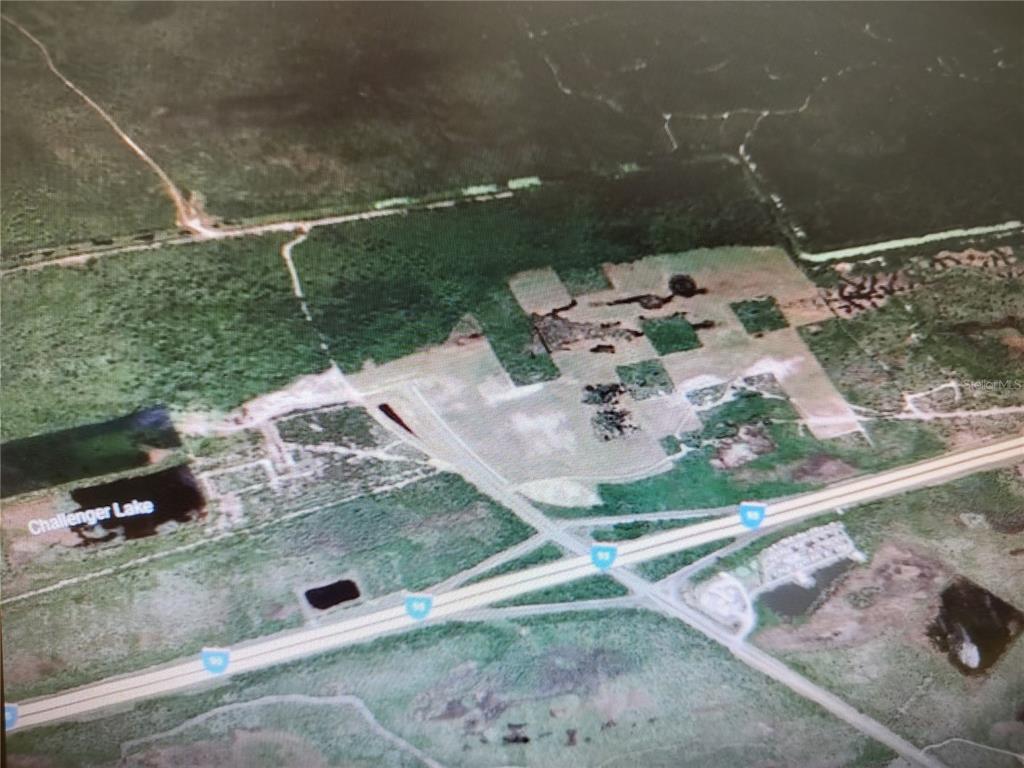 An aerial view of a plot of land near Challenger Lake and a highway intersection — 00 DEERING PARKWAY, MIMS, FL