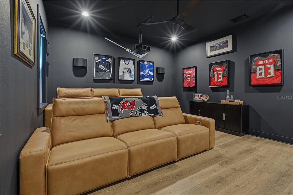 A room with two blue armchairs, a large abstract painting, and an open doorway — 4208 N CLEARFIELD AVENUE, TAMPA, FL