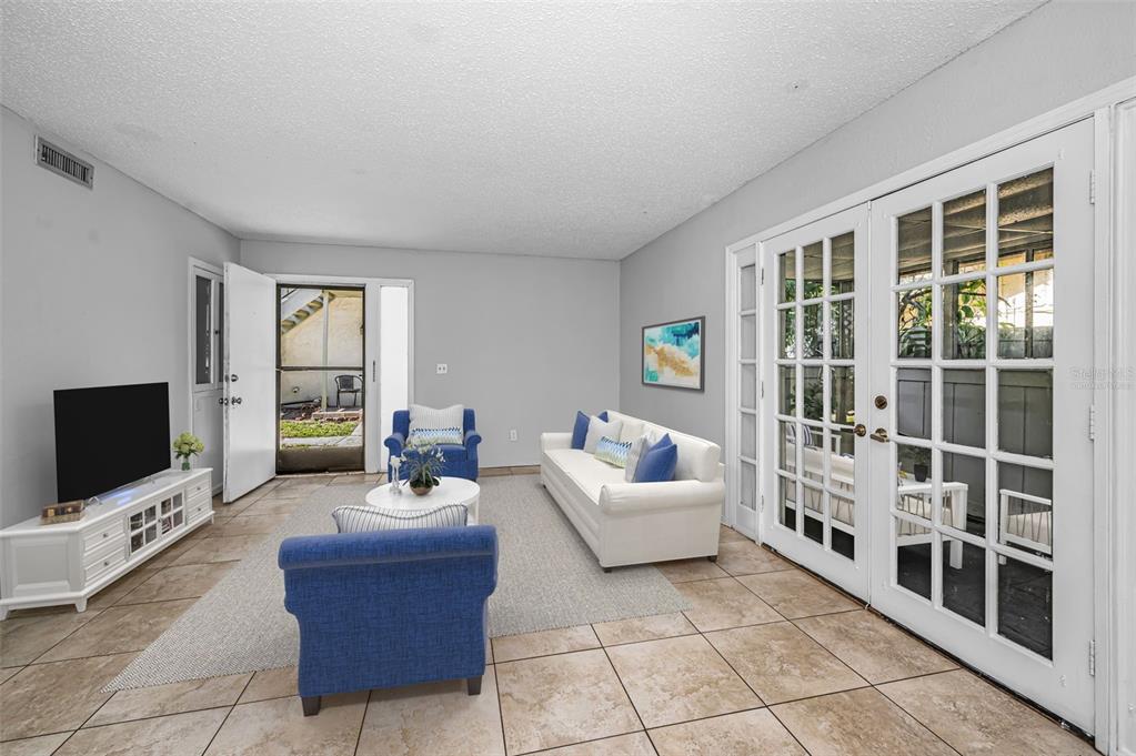 An exterior view shows a ground-level entrance with a brick porch and an outdoor staircase — 1960 UNION STREET UNIT 5, CLEARWATER, FL