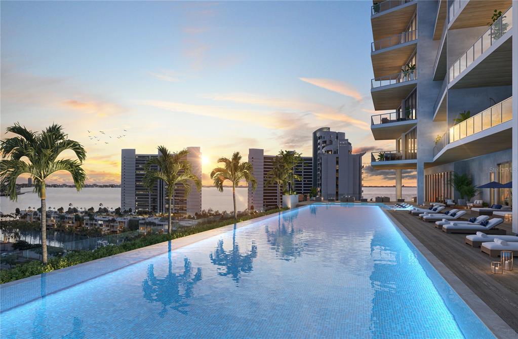 This architectural rendering shows an infinity pool on a balcony overlooking a sunset and buildings — 668 QUAY COMMONS UNIT 102, SARASOTA, FL