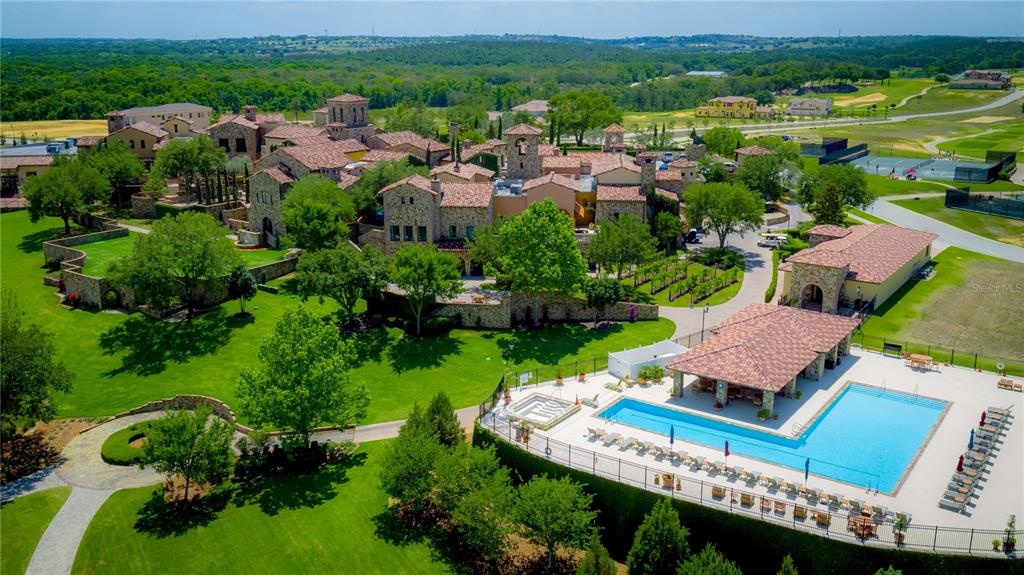 An aerial view shows a large stone estate with a pool, patio, and landscaped grounds — 16122 TRIVOLI CIRCLE, MONTVERDE, FL