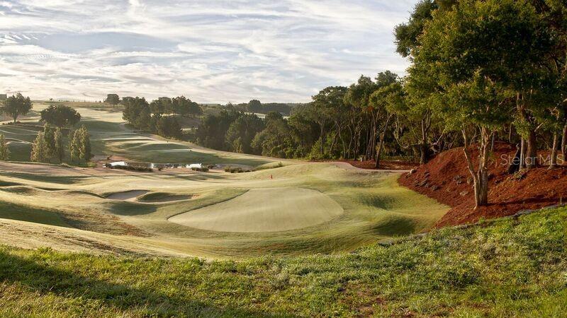 A view of a golf course fairway with a putting green, sand bunkers, and trees — 16122 TRIVOLI CIRCLE, MONTVERDE, FL