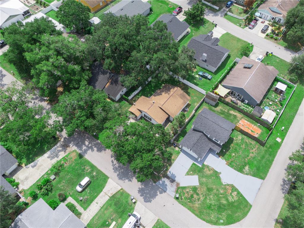 An aerial view shows several suburban houses with driveways, green lawns, and mature trees — 1665 SAILPOINT DRIVE, BARTOW, FL