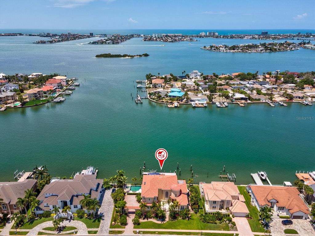 An aerial view shows a waterfront house with a pool and dock on a bay — 6224 PASADENA POINT BOULEVARD, GULFPORT, FL