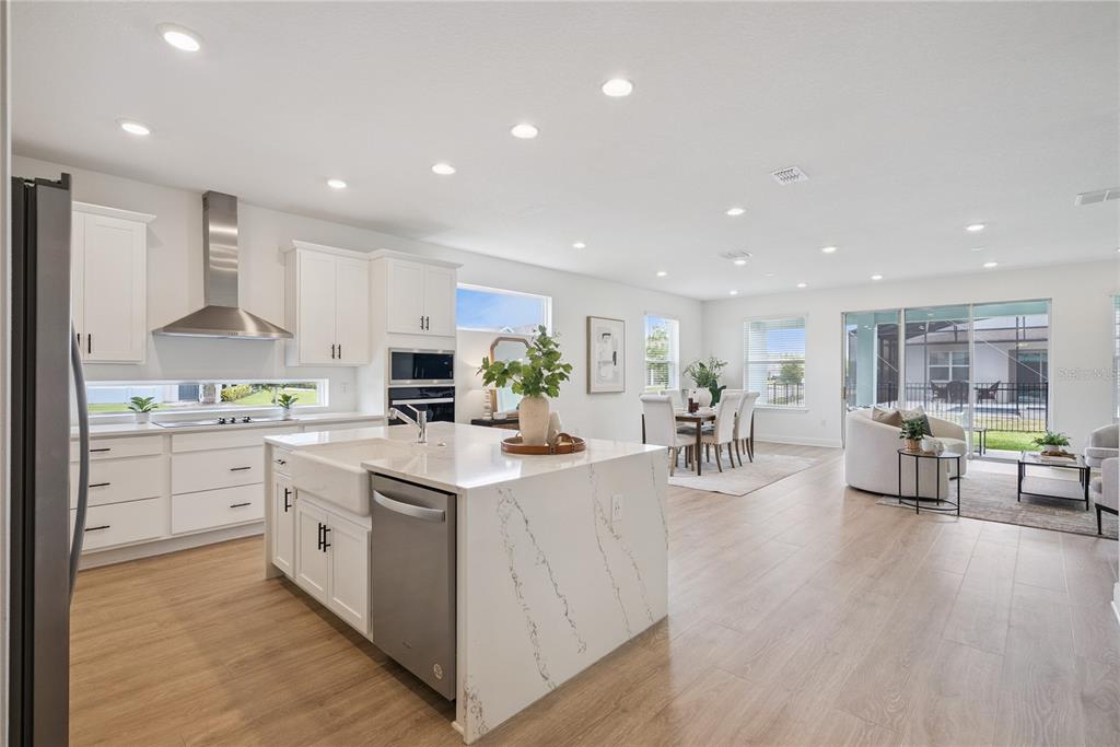 A single-story house with a two-car garage and a paved driveway under a blue sky — 19307 BANFIELD PLACE, ORLANDO, FL