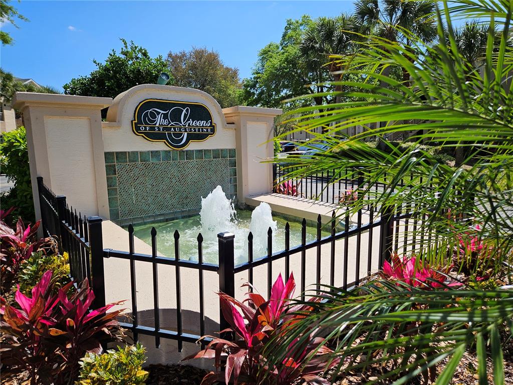A decorative fountain with a sign for The Greens of St. Augustine stands outdoors — 710 AUGUSTA CIRCLE UNIT 11A, ST AUGUSTINE, FL