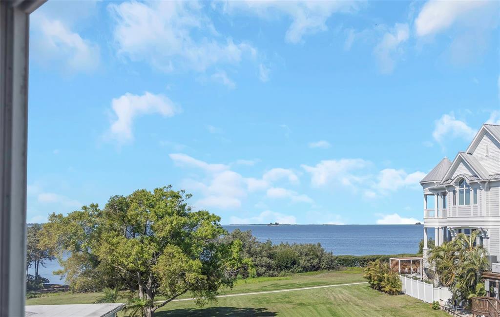An aerial view shows several multi-story coastal homes near the ocean at sunset — 606 INDIANA AVENUE, CRYSTAL BEACH, FL